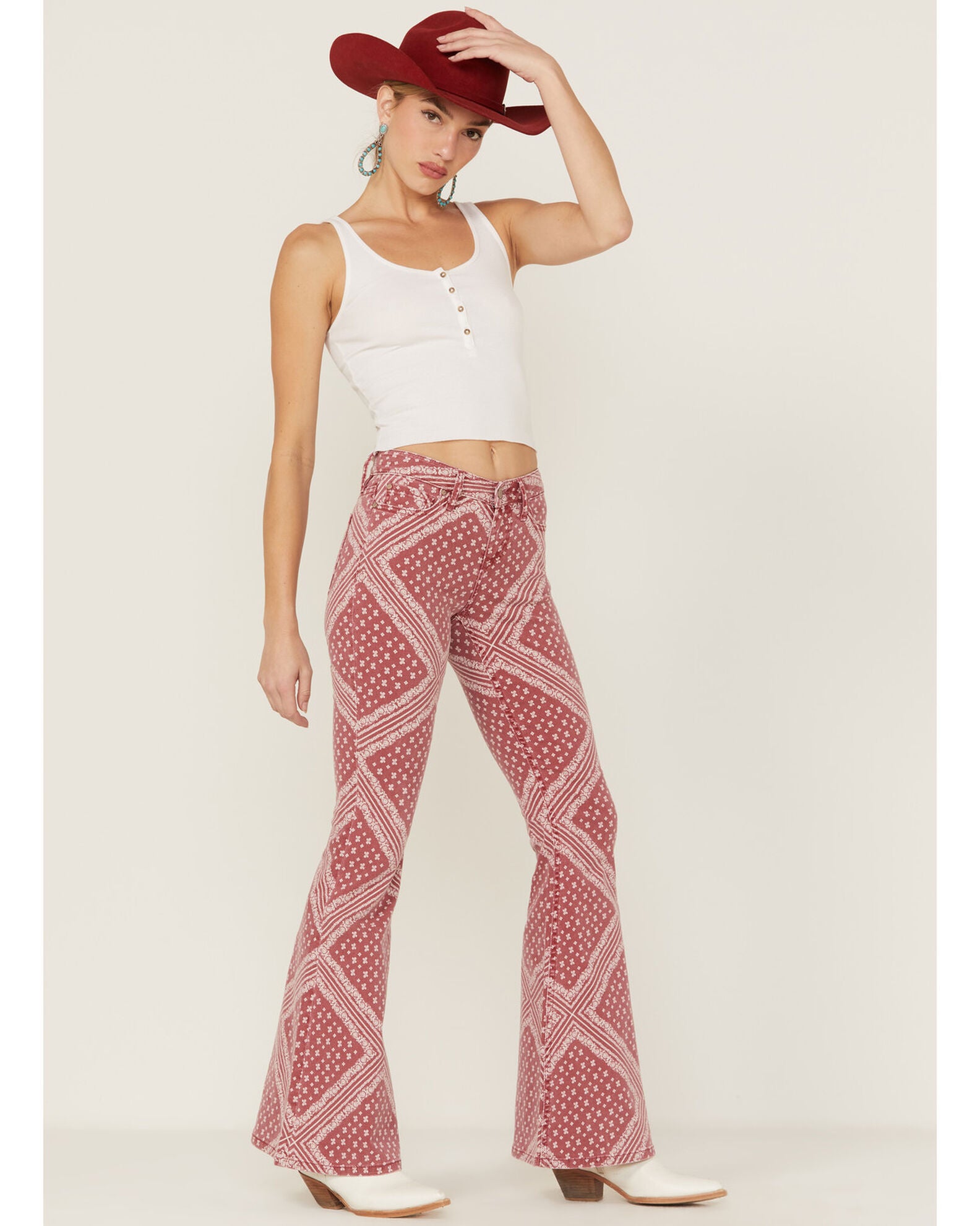 A product image showcasing the intricate details of red bandana print jeans